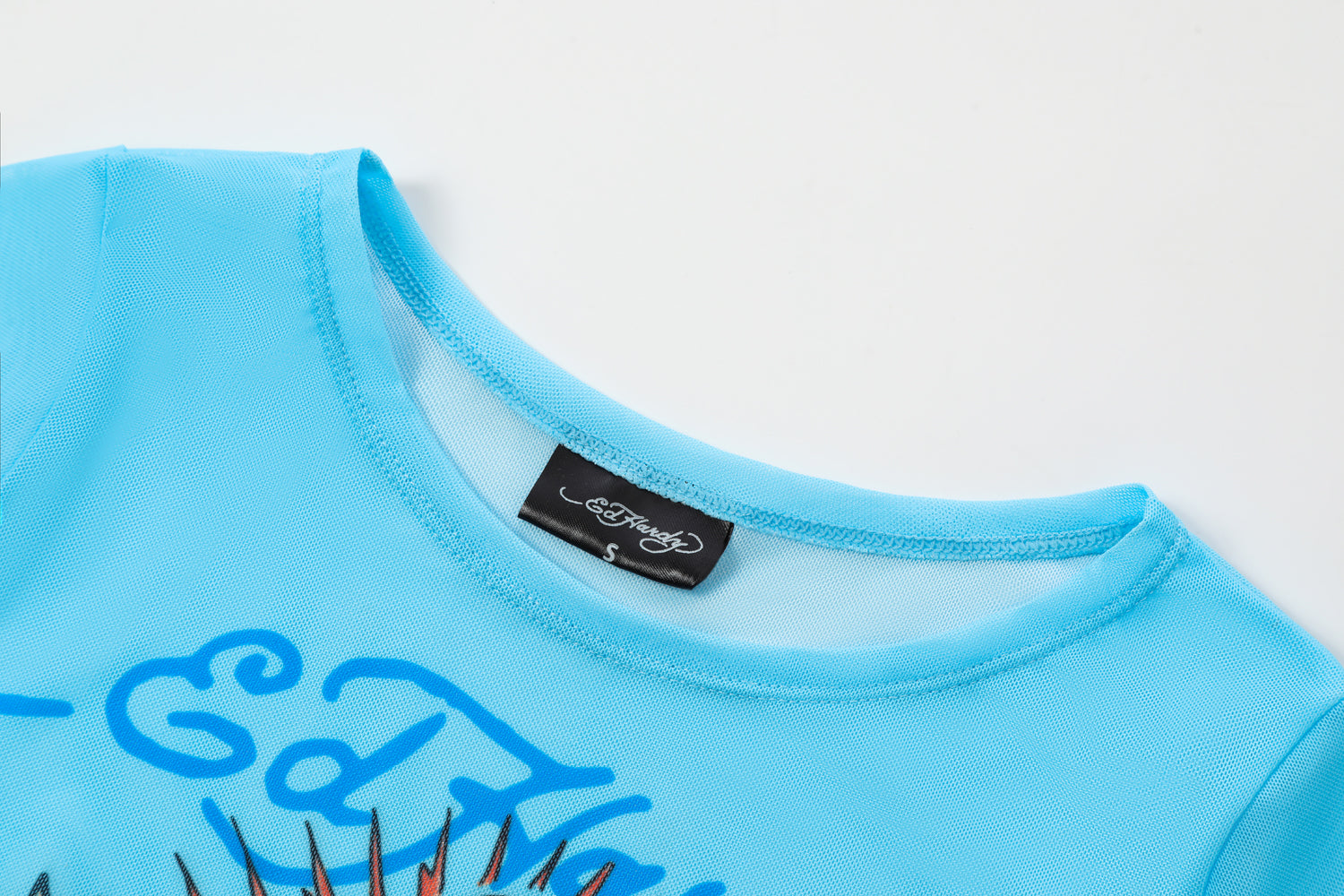 Close-up detail of Ed Hardy Sky Pantheress Swim Tee in light blue print