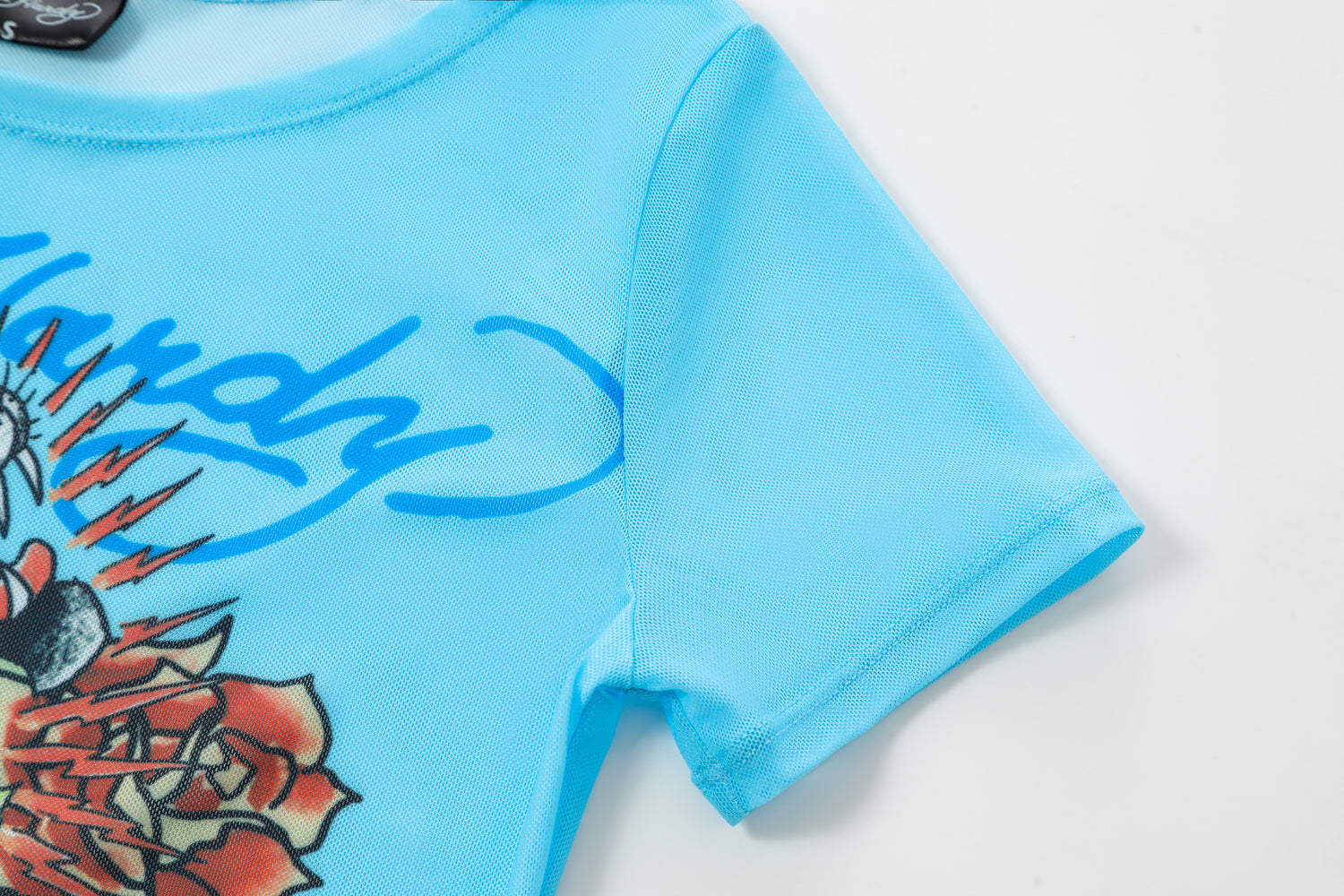 Close-up detail of Ed Hardy Sky Pantheress Swim Tee in light blue print