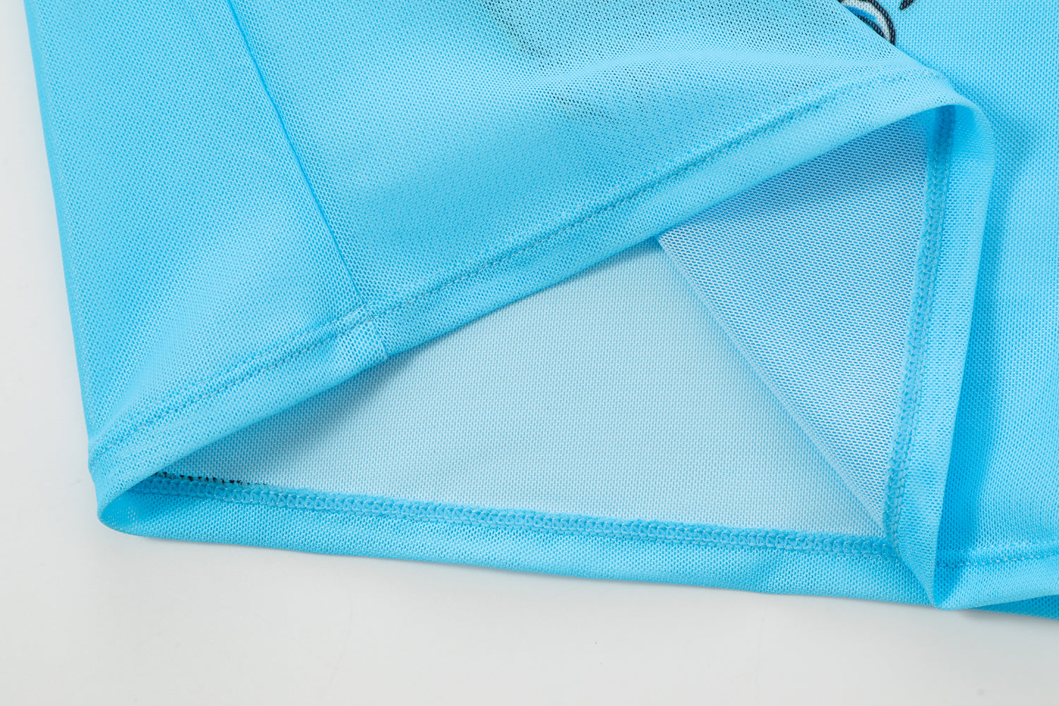 Close-up detail of Ed Hardy Sky Pantheress Swim Tee in light blue print