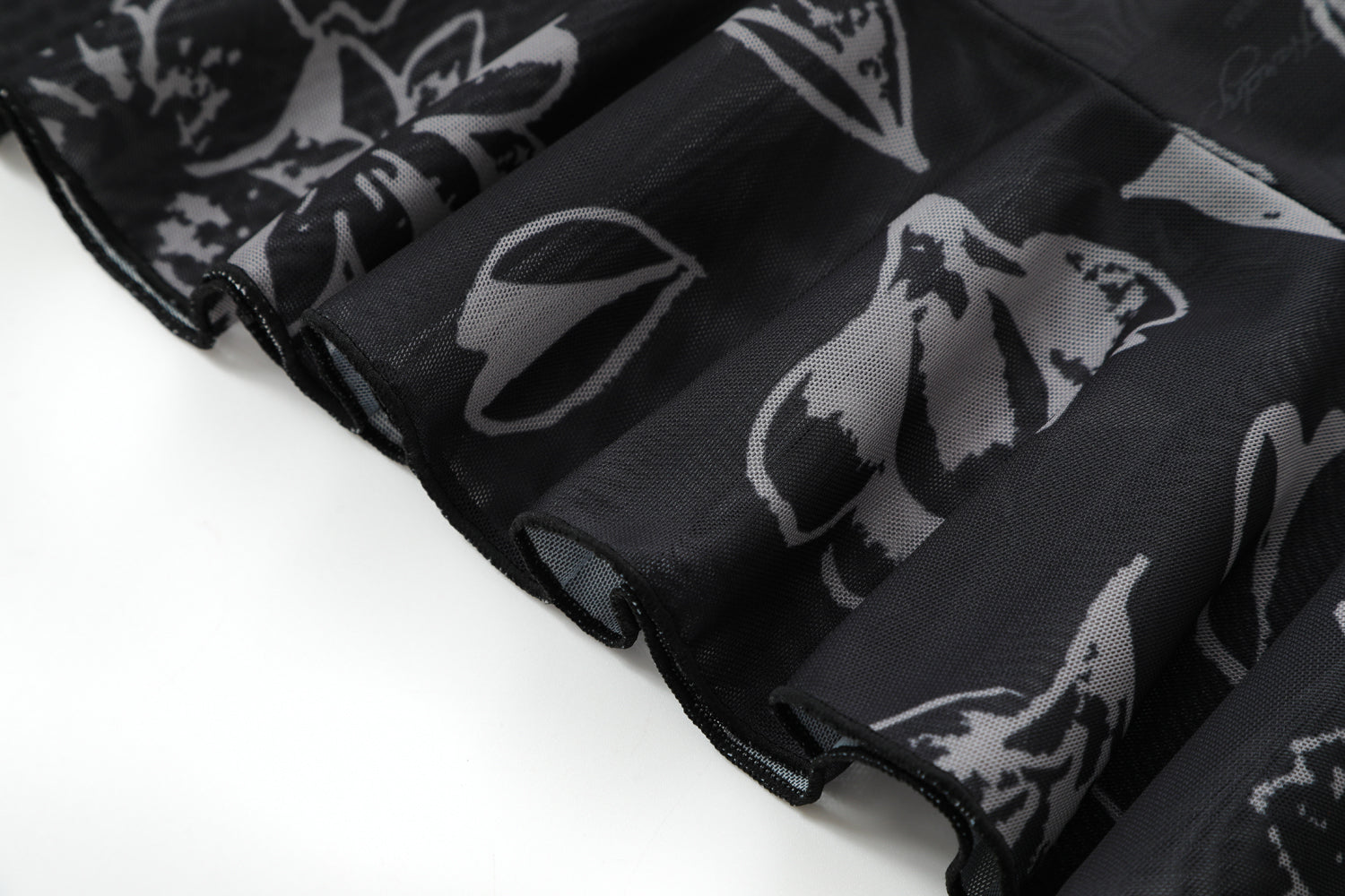 Close-up detail of Ed Hardy Night Angel Mesh Skirt in black print