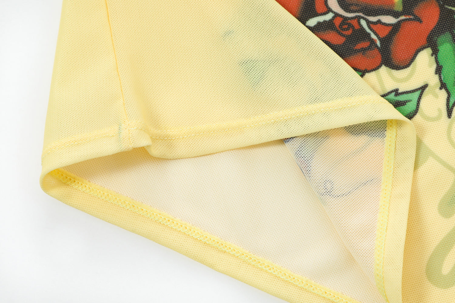 Close-up detail of Ed Hardy Vintage Rose Swim Tee in yellow print