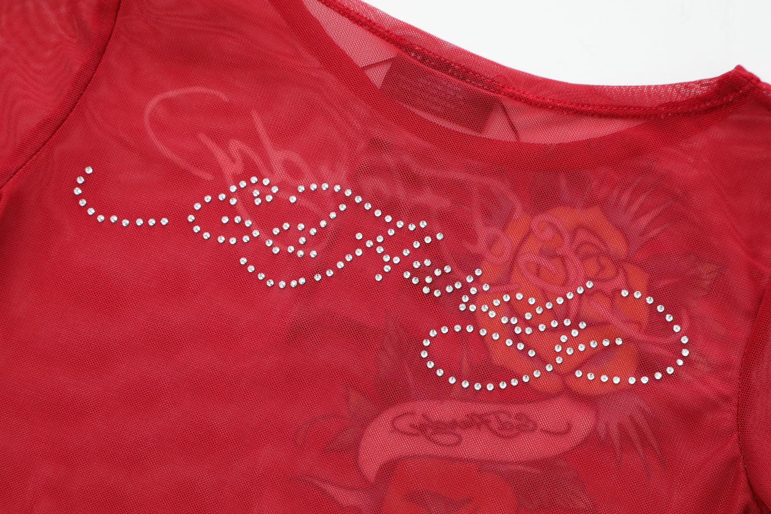 Close-up detail of Ed Hardy Rebel Rose Mesh Maxi Set in red print